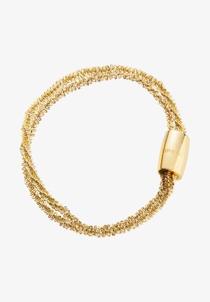 Kultainen rannekoru, jossa on toisiinsa kiedottuja ketjulukkoja ja sylinterimäinen kiinnitys, jossa on kaiverrettuna "BREIL". Yksinkertainen, kiemurteleva muotoilu ja sileä pinta.