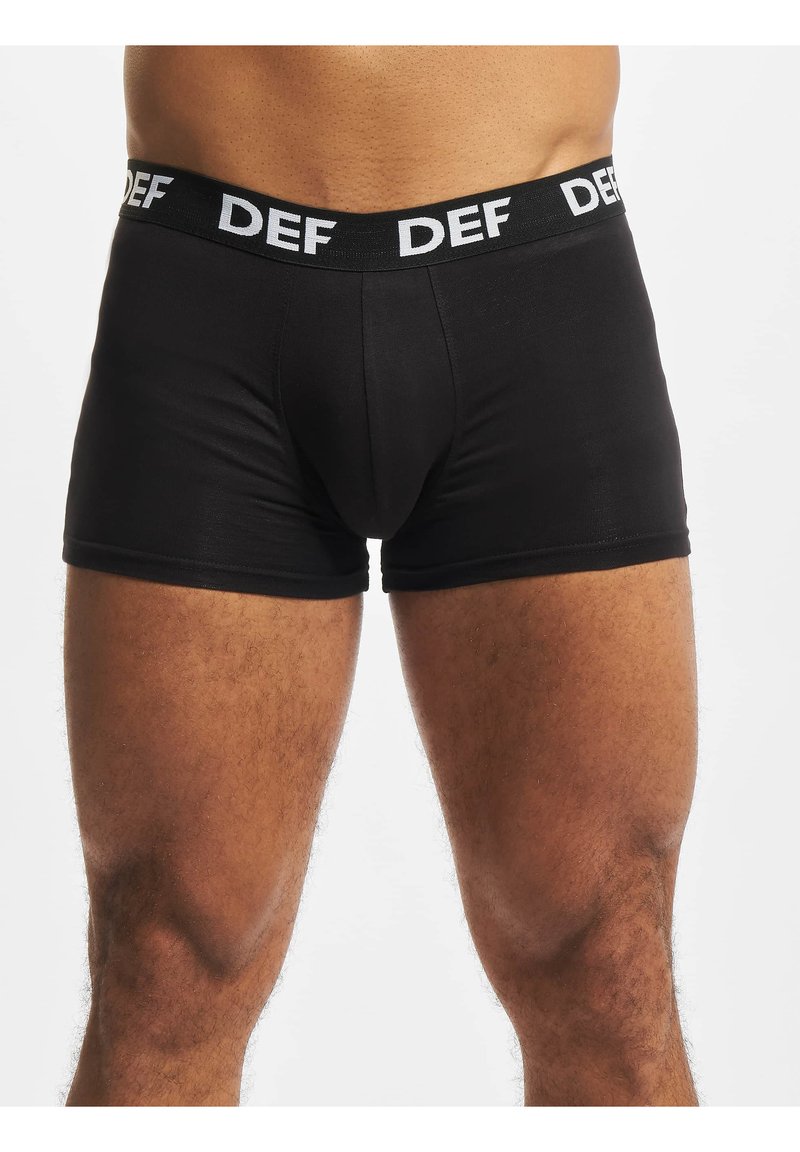 Black cotton boxer briefs with a fitted design, elastic waistband featuring "DEF" in white lettering, smooth texture, and mid-thigh length.