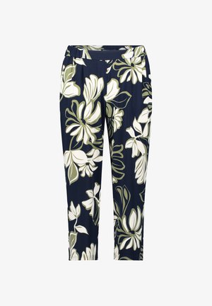 Pantalons capri à imprimé floral en bleu marine avec de grandes fleurs blanches et vertes. Dotés d'une taille élastique et d'une coupe décontractée. Tissu doux au toucher.