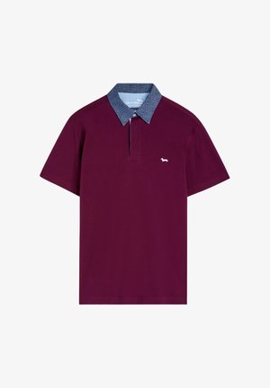 Burgundy polo shirt with a patterned blue collar, short sleeves, and a white logo on the chest; made of soft, textured fabric.