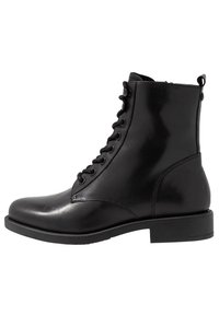Botas de cuero negro hasta el tobillo con puntera redonda, cordones en la parte delantera, suela de goma plana y tirador en la parte trasera. Textura suave con acentos mínimos.