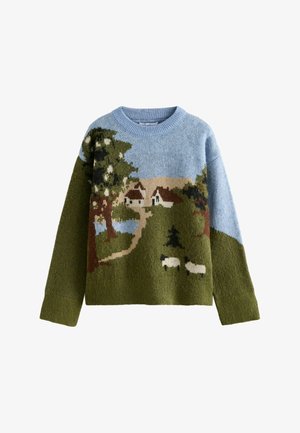 Pull avec un motif de paysage représentant des champs verts, un ciel bleu, des arbres, deux maisons, un chemin sinueux et deux moutons blancs.