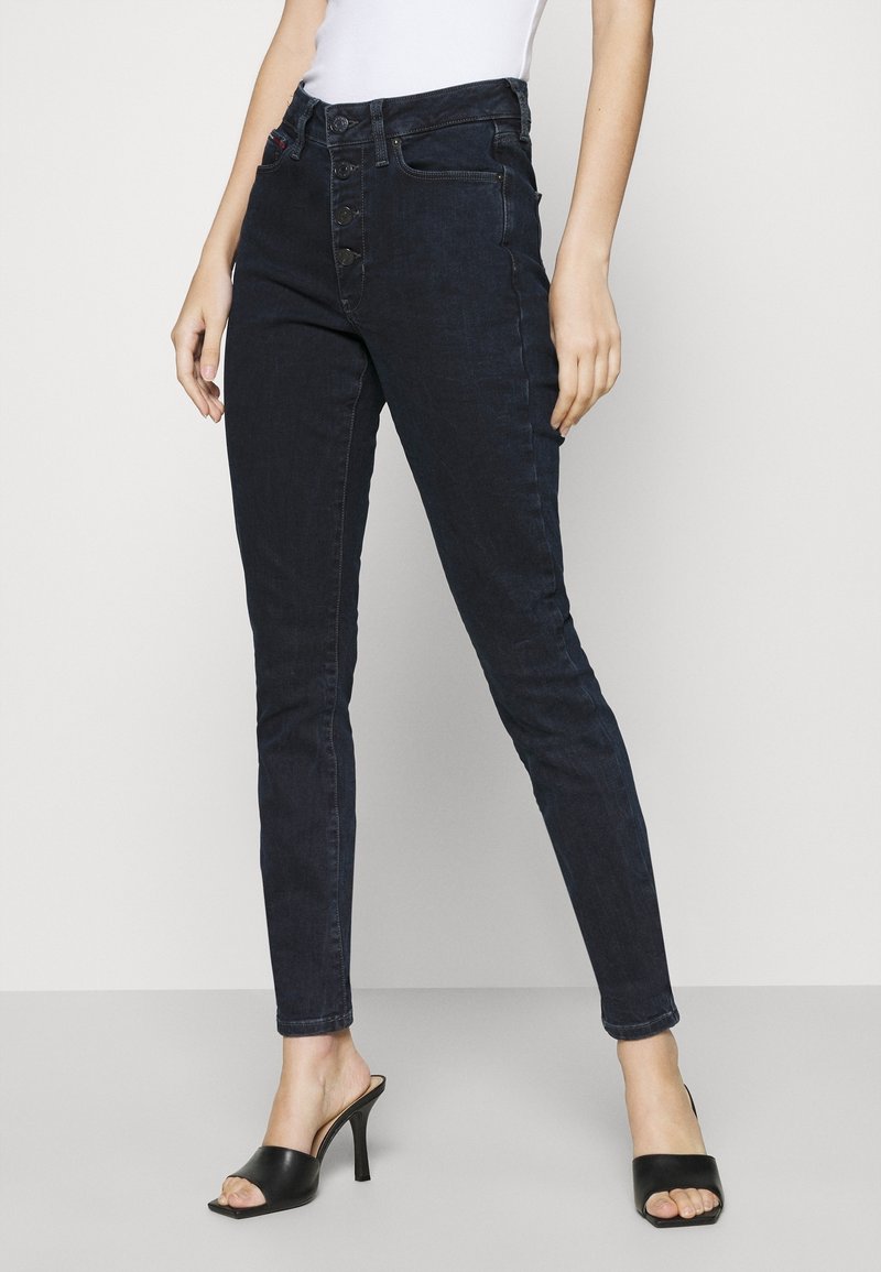 Mörkblå högmidjade skinny jeans med femknapprad. Släta denimtyg, slim fit, med framfickor och bakre sömadresser.