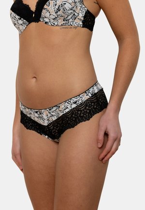Sous-vêtements noirs à motifs floraux bordés de dentelle, avec un mélange de tissu couleur chair et blanc, dotés de détails en dentelle élaborés à la taille.