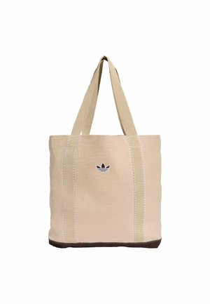 Beige lærredsnettaske med lange hanke, brun bund og lille sort Adidas-logo centreret foran.