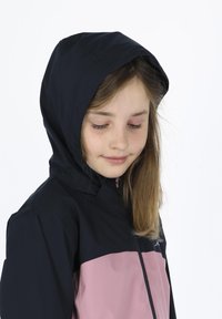 Black and pink zip-up jacket with a hood, made of smooth fabric. Features a two-tone design, with contrasting colors on the upper and lower sections.