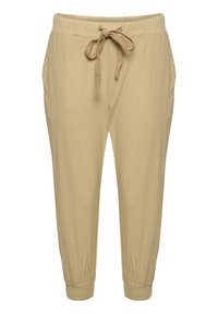 Beige lichtgewicht taps toelopende broek met een elastische tailleband, verstelbaar trekkoord, zijzakken en elastische boorden bij de enkels.