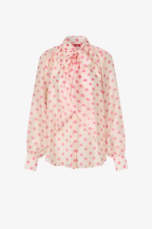 Bluză crem cu buline roz aprins, mâneci lungi, manșete cu nasturi și un mare fund la gât.