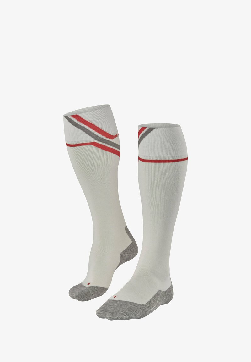 Calze fino al ginocchio di colore crema chiaro con strisce rosse e grigie. Realizzate in un tessuto morbido, con punta e tallone grigi rinforzati.