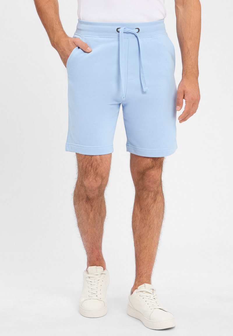 Light blue cotton shorts with an elastic waistband, drawstring, and side pockets. Available with rolled cuffs and a smooth texture.