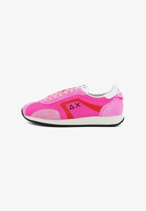 Pink low-top sneaker with light pink laces, red geometric accents, black symbols on the side, white sole, and black tread.