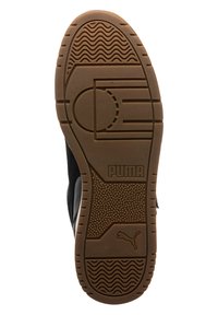 Black sneaker bottom with gum rubber sole. Features patterned treads and Puma logo, with curved design along the edges for traction.