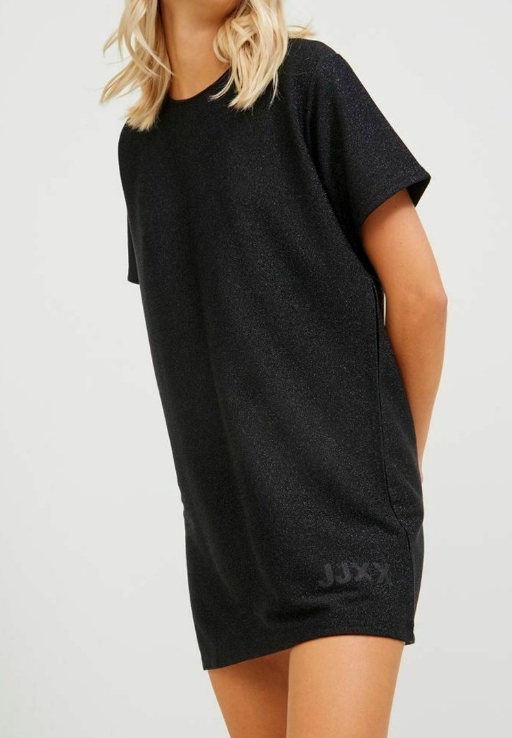 Black short-sleeve dress made of textured, lightweight fabric featuring a subtle shimmer. Side slits and "JJXX" logo accent the hem.
