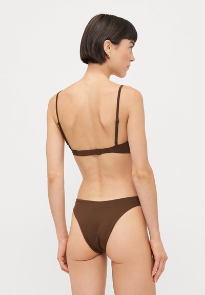 Brown bikini set featuring a minimal design with thin adjustable straps, hook closure at the back, and high-cut bottoms. Smooth texture.