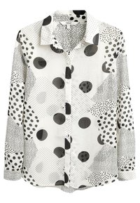 White blouse featuring a mix of black polka dots and geometric patterns. Crafted from smooth fabric with a collared neckline and button front.