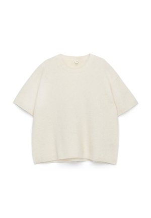 Cream-colored short-sleeve sweater made of soft, textured fabric. Features a round neckline and relaxed fit with ribbed hems.