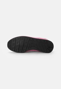Pink sneaker with a textured black rubber outsole. Features a pink upper with a smooth finish and a striped design along the sides.