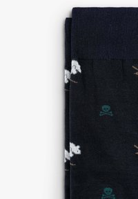 Marine sokken met een patroon van witte schapen en groene schedels. Gemaakt van zacht materiaal met een geribde boord en een gladde textuur.
