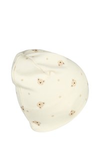 Cotton beanie in cream with soft bear face illustrations and light brown polka dots. Soft texture and rounded shape for comfort.