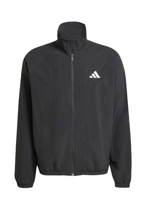Svart zip-up jacka med hög krage; tillverkad av lätt material. Har en vit logotyp på bröstet samt elastiska ärmslut och nederkant.