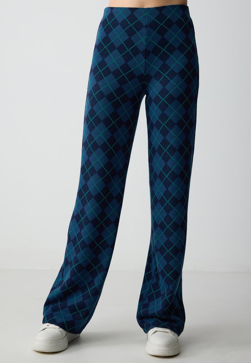 Pantaloni a gamba larga in navy con un motivo argyle verde e blu. Realizzati in tessuto testurizzato, presentano un alto punto vita e una vestibilità comoda.