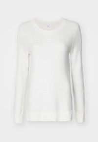 Pull blanc à manches longues avec un motif de tricot texturé, col rond et poignets et ourlet côtelés. Fabriqué en tissu doux.