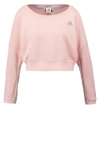 Felpa cropped rosa con un motivo a trama, scollo rotondo e maniche lunghe. Presenta il logo Adidas in grigio sul petto.