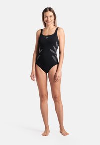 Black one-piece swimsuit with a fitted design. Features silver leaf-like accents on the sides and thick shoulder straps. Smooth texture.