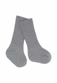 Paar grijze gebreide antislip sokken met rubberen grip op de zolen en tenen voor extra grip.