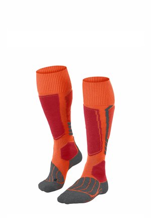 Calcetines hasta la rodilla en un brillante color naranja con detalles en rojo y gris. Parte superior acanalada, secciones acolchadas y puntera reforzada para mayor durabilidad.