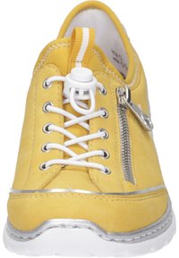 Yellow suede sneaker with a white rubber sole, featuring elastic laces, a side zipper, and a silver accent around the base.