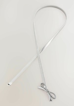 Silverfärgat metallbälte med en slät, plan design. Har en dekorativ rosett i ena änden och en texturerad yta längs hela längden.