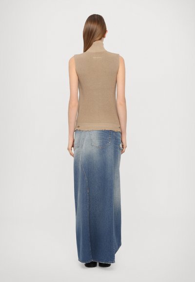 Beige ribbed turtleneck sweater paired with a long blue denim skirt. The outfit features a fitted top and a flowing, distressed skirt design.