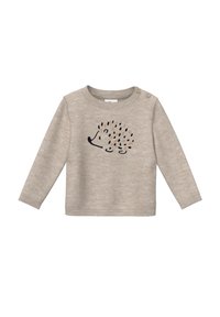 T-shirt beige à manches longues en tissu doux, arborant une illustration de hérisson avec des points colorés, et deux détails en boutons sur l'épaule gauche.