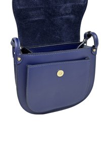 Mała granatowa skórzana torebka na ramię z otwartą klapą, przednią kieszenią i złotym zapięciem na zatrzask.