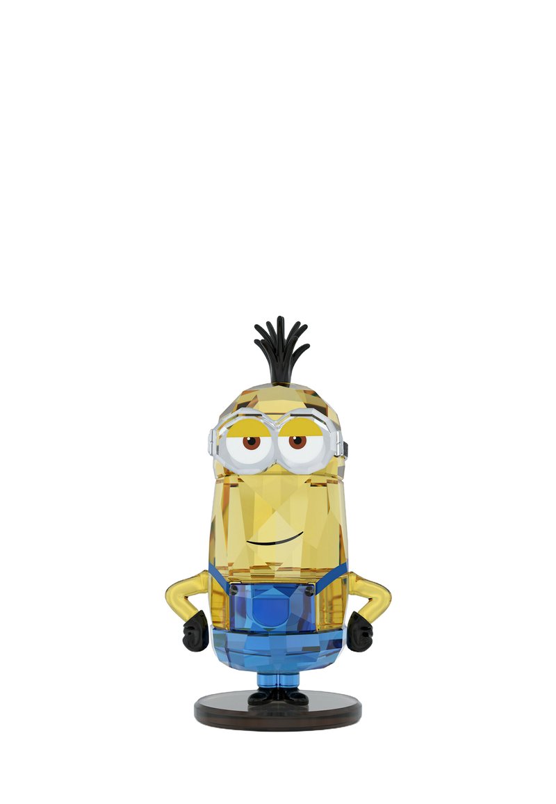 Figurina di cristallo di un Minion, con un design geometrico giallo, blu e nero, occhi grandi, che si erge su una base circolare nera.