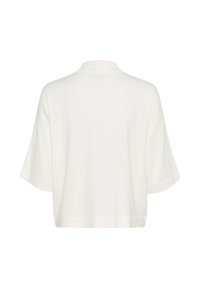 White, oversized short-sleeve pullover with a high neckline and a straight hem. Soft texture, minimal design, and no visible patterns.