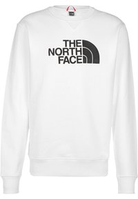 Bílá mikina s velkým černým logem "THE NORTH FACE" a zaobleným designem. Hladký límec, manžety a lem. Hladká textura.