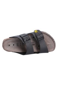 Black two-strap sandal with adjustable buckles, cork footbed, and a textured rubber outsole. Features embossed brand logo on insole.