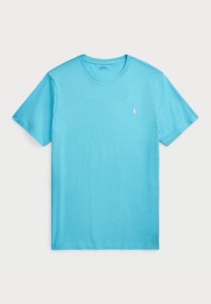 T-shirt en coton bleu clair à col rond avec des manches courtes et un petit logo brodé sur la poitrine gauche. Design lisse et décontracté.