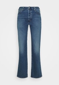 Jeans acampanados de denim azul oscuro con un diseño de cinco bolsillos, cierre frontal con botón y un ligero desgaste en las piernas. Textura suave en toda la prenda.