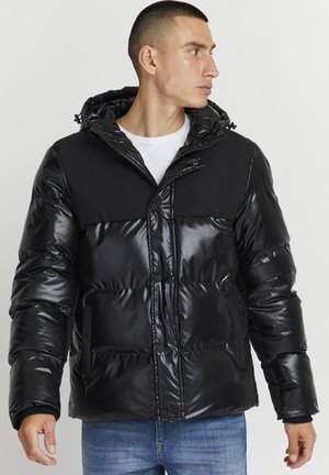 Black puffer jacket with a glossy finish, featuring a hood, snap buttons, and contrasting matte fabric on the upper section.