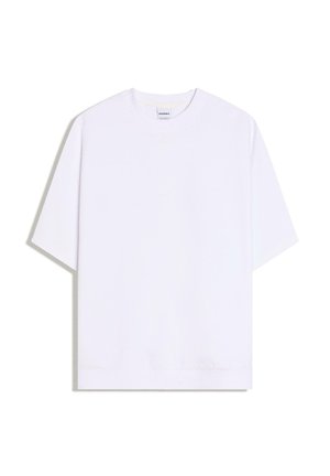 T-shirt blanc uni oversize à manches courtes avec encolure ronde, posé à plat sur fond blanc.