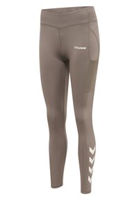 Bruine sportlegging met een hoge tailleband, zijzak en een wit chevronpatroon langs het onderste deel van het been. Gemaakt van rekbaar, ademend materiaal.