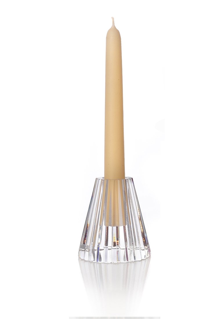 Przezroczysty szklany świecznik o rozkloszowanym, żebrowanym wzorze. Trzyma wysoką, beżową świecę, tworząc kontrastowy kształt i kolor.