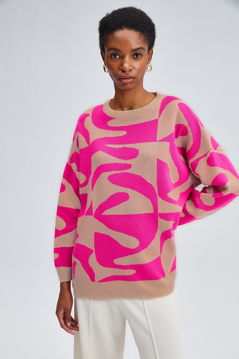 Maglione oversize lavorato a maglia in beige e rosa vivo con motivo astratto. Caratterizzato da un collo a giro e polsini a costine sulle maniche e sul fondo.