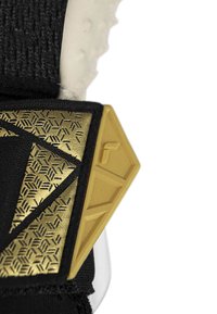 Svart tygrem med ett texturerat guldaccenterat mönster med geometriska former och en elegant hårdvarudesign. Ytterligare vita detaljer syns.