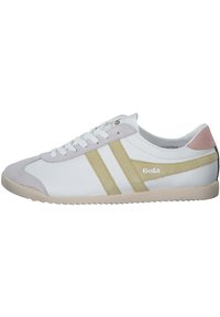 White sneaker featuring a suede toe cap, gold stripes, and a pastel pink heel. The sole is textured and light-colored for traction.
