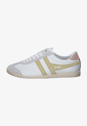 White sneaker featuring a suede toe cap, gold stripes, and a pastel pink heel. The sole is textured and light-colored for traction.