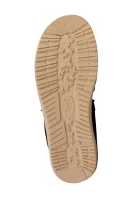 Scarpa nera con suola in gomma beige testurizzata, caratterizzata da un motivo di scanalature e dettagli floreali per una migliore aderenza.